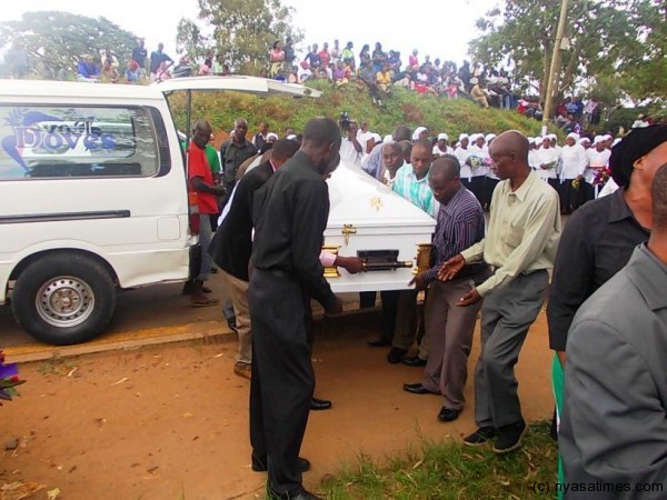 Kapenuka's  white and gold plated casket  being carried at the cemetery...Photo Jeromy Kadewere