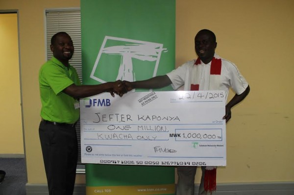Kaponya receives a symbolic cheque from TNM's Limbani Nsapato