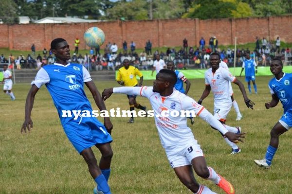 Karonga United in blue as Peter Wadabwa trying to win the ball...Photo Jeromy Kadewere