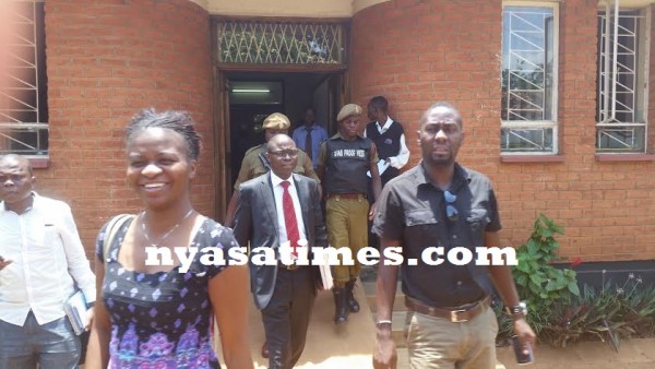 Kasambara coming out of Lilongwe High Court on Thursday to to board police car PS 043 registration number off to prison on remand.-Photo by Mphatso Nkhoma, Nyasa Times