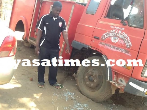Kasungu Municipality PRO Mr Kadyakapita shows journalists the broken grasses as damaged by the vendors