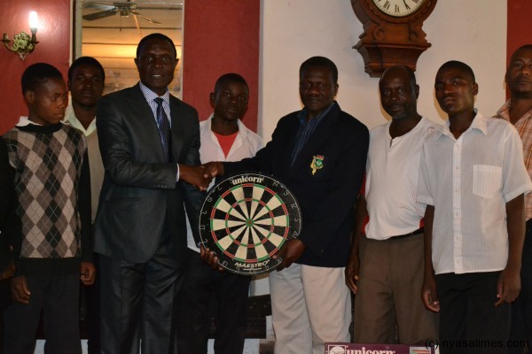 Katola (3rd left) receives donation from one of the companies