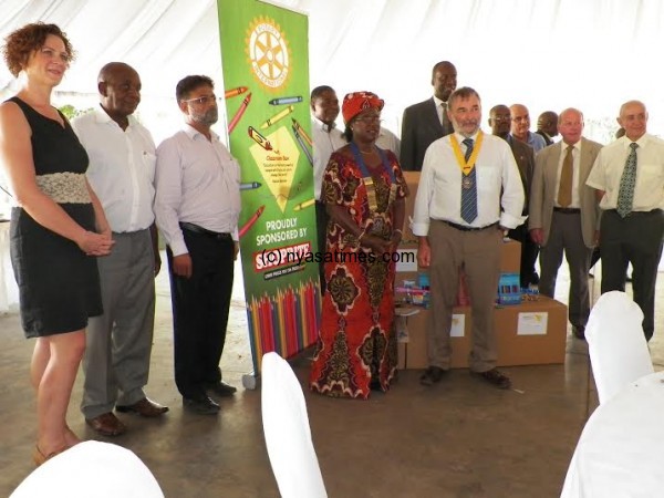 Kitchen (5th from left) poses with local  Rotarians after handing over the material