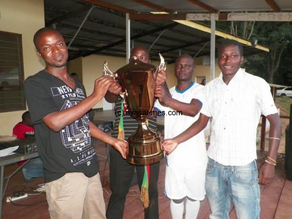 LGC Operations Manager Arthur Chirwa presents the trophy to Bonkiri Bonkiri