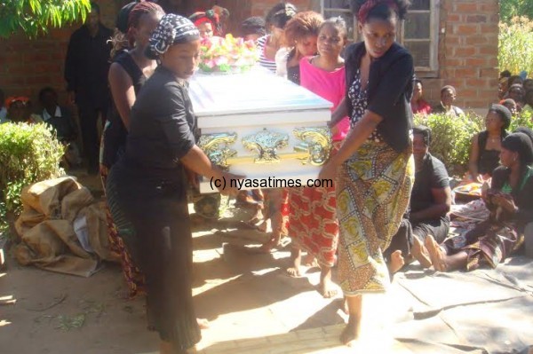 Ladies carrying the casket  where Faith is resting for burial