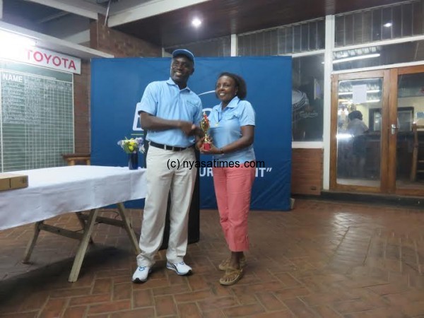 Ladies champ Bailey gets her trophy from Asiedu.