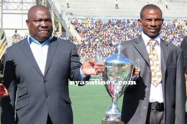 Lovemore Fazili and Bob 'Mpulumutsi' Mpinganjira carrying the cup
