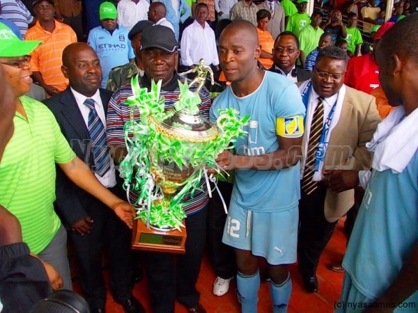 Lucky Malata as captain receiving a trophy from Sports Minister Enock Chihana