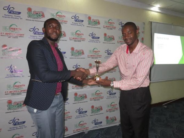 Luwemba presents an award to Nyirenda (in jacket)