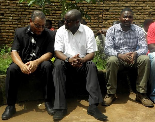 MBC Director General Dr Benson Tembo (L) shares with MISA Malawi Chairperson ... ile Bright Malopa, former MBC boss looks on at the bereaved's house- Pic Lucky Mkandawire.