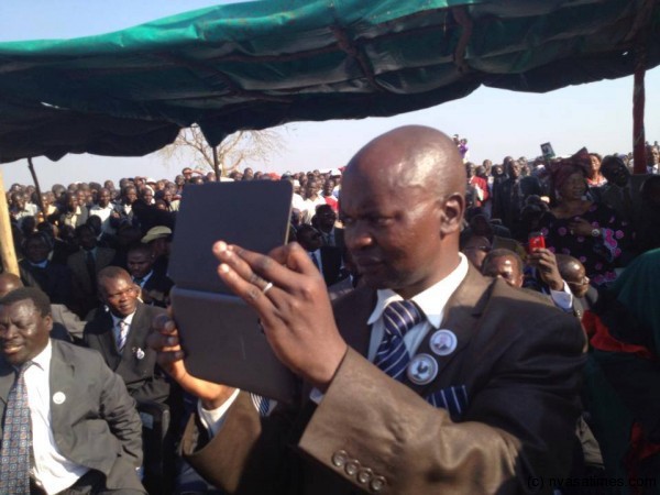 MCP lawmaker Jolly Kalero with his 'kantchini' (ipad) taking photos at the rallt