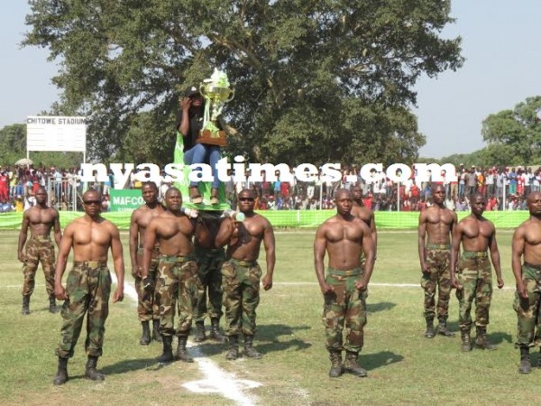 MDF soldiers carry a lady holding the old trophy, Pic Alex Mwazalumo