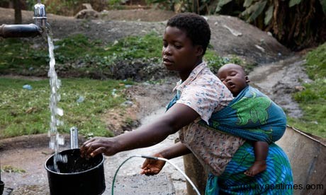 A young mother carrying her baby gets water at a well at St Luke s District Hospital in Zomba, Malawi, where the rate of child marriage is 50%. Photograph: Simon Rawles/Alamy