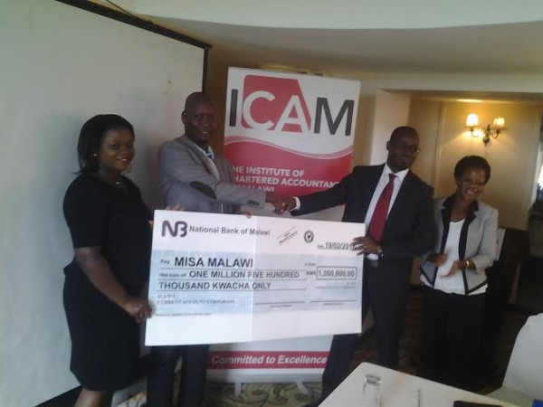 MISA-Malawi Chairperson, Thom Khanje, receiving a dummy cheque from ICAM