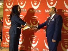 Macra board chair Alissa Makawa handing over  the licence to Lacell Board Chair Sattar