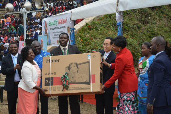 Madam Mutharika and Chinese Ambassador Handing over a TV set to the grand winners Lilongwe Academy Principle