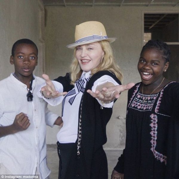 Mercy and David with mum in Malawi: Madonna has been blasted for using the Kenyan flag during a family trip to Malawi
