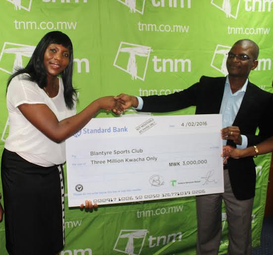 Makata presenting a dummy cheque to Karuku during the sponsorship launch