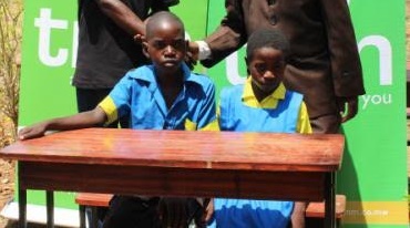 Pupils at Nkokachombwe Primary School sits on the donated desks
