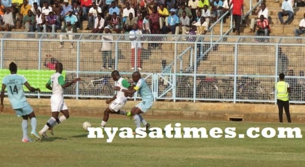 Malata keeps a close check on a Mafco striker, Pix Alex Mwazalumo