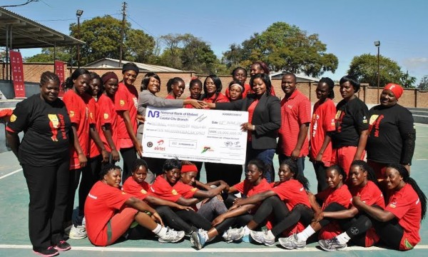 Malawi Queens in a group photo with Airtel officials who presented the cheque.....Photo Jeromy Kadewere
