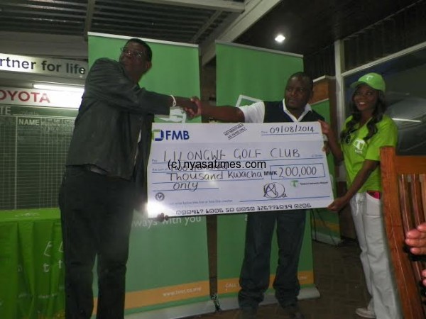 Malisita presents dummy cheque to LGC chair Justin Mkandawire