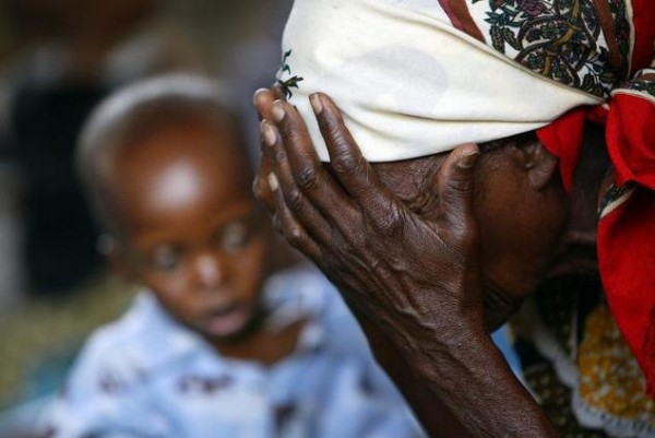 A Malawian grandmother rests on October 14, 2005, close to her malnoureshed grandson in Zomba ©Gianluigi Guercia, AFP