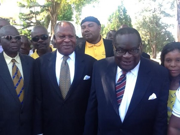 Maloni being seen here in yellow golf shirt behind Bakili Muluzi