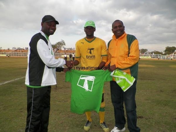 Man of the match John Lanjesi gets his prize from Sulom's Aggrey Khonje and TNM official