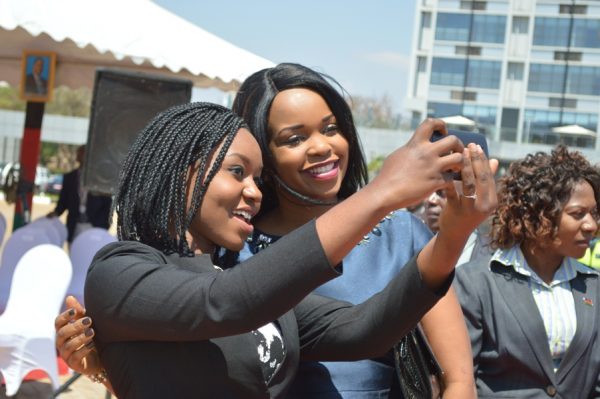 Mary Chilima spounse to the Vice President taking self photograph with one of the girls at the National girls conference in Lilongwe on Thursday.(C)govati nyirenda. mana. (1)