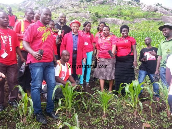 Mayor pose with Airtel staff.-Photo by Anthony Kasunda