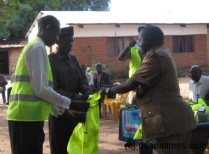 Medi ,handing over reflectors to Senior Group Village Headman Mwangolera at Mlale....picture by Tiwonge Nyirenda