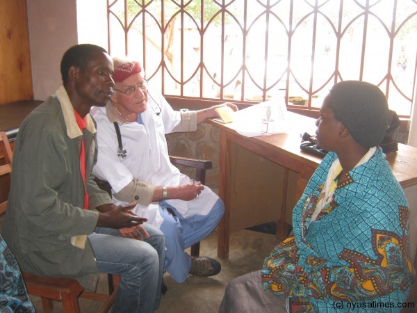 Medical doctor Richard, attending to the a female pateient through an interpreter