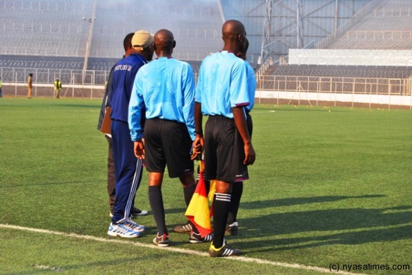 Match officials consulting each other after supporters were dispersed with teargass....Photo Jeromy Kadewere