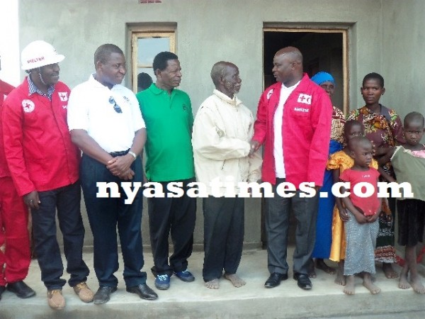 Mhango shakes hands with on eof the beneficiaries as others look on-Lapken Kapoto 