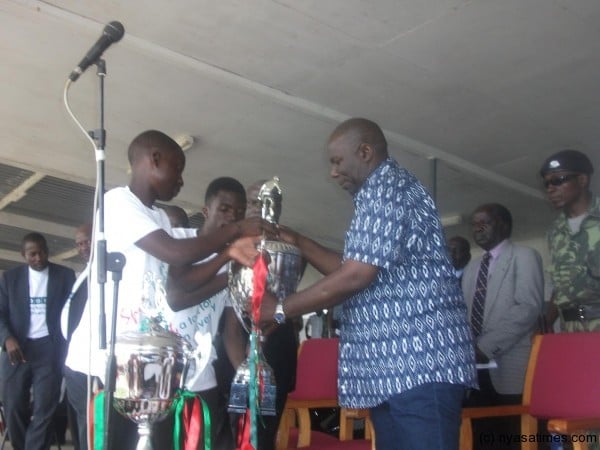 Minister Chihana receives trophies from girls to launch PIS at Mzuzu stadium