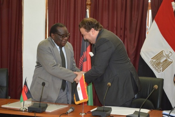 Minister of Finance and Economic planning Goodall Gondwe shakes hands with Ambassodor of Egypt to Malawi Maher Adel El-Adawy (C) Stanley Makuti
