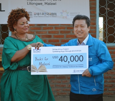 Minister of GenderPatricia Kaliati symbolically receives donation of 40000 from the Secretary General of Korea National Commision for UNESCOMr.Dong-seok Min - Pic by Stanley Makuti 2