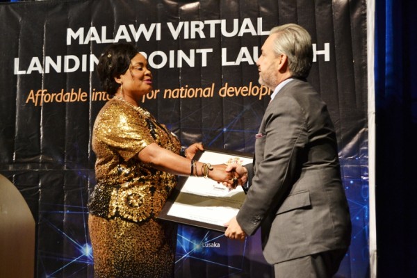 Minister of ICT and Civic Education, Patricia Kaliati, presents a Certificate to SimbaNet Chief Executive Officer, Santiago Benedit at BICC in Lilongwe-(c) Abel Ikiloni, Mana