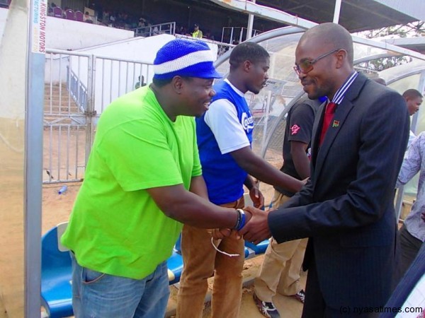 Minister of Information Moses Kunkuyu shaking hands with Nomads top fan Yona Malunga who coached the side....Photo Jeromy Kadewere
