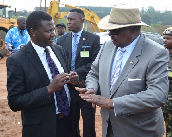 Minister of Transport Malison Ndau briefs President Mutharika about the road project at Nambala wani trading centre during during the inspection of the project