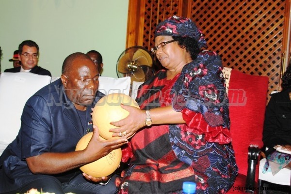 Minister of Youth and Sports Development Enoch Chihana with President Bnada admiring the orange balls