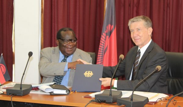 Minister-of-finance-Dr.Goodall-Gondwe-exchange-documents-with-the-Federal-Republic-of-Germany-Ambassador-to-Malawi-Jurgen-Borsch-at-Capital-Hill-C-Stanley-Makuti.