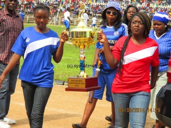 Models with a trophy to the VIP Stands....Photo Jeromy Kadewere.