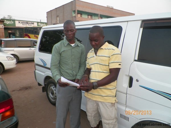 Moliati (left) and Mwandira pip through the contract