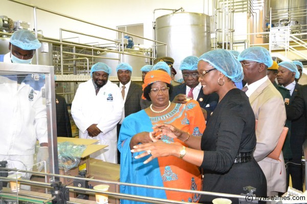 First Lady Mrs Mugabe explaining to JB how the machines work