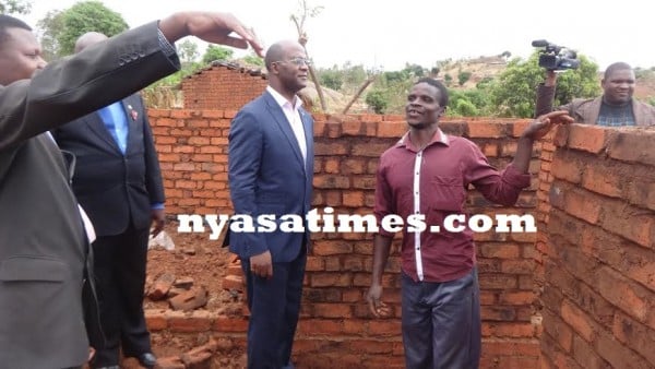 Muluzi (Centre) inspecting one of the houses