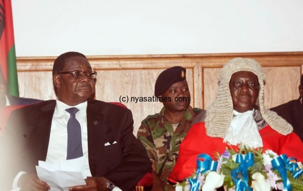 Mutharika (L) looks on before being sworn in as the country's newly elected president 