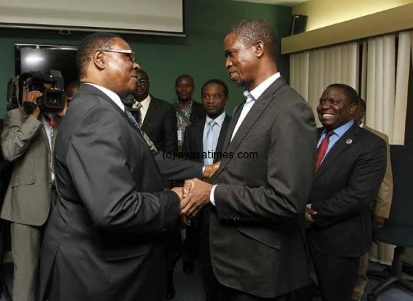 Congratulatory handshake: Mutharika (L) shakes Lungu’s hand