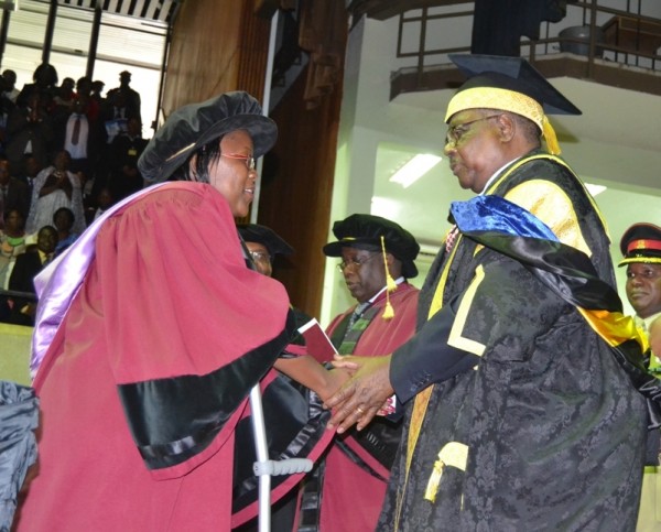 Mutharika awarding an honorary degree to one of the female graduants during the function.Pic-Francis Mphweya-MANA.